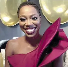  ?? E! Entertainm­ent ?? YVONNE ORJI, in a screen grab from E!’s coverage, is all smiles in a red, liquid sequin, one-shoulder gown with crepe ruff led detailing from Azzi & Osta.