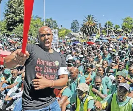  ?? /Russell Roberts. © Financial Mail ?? Cross-purposes: Amcu workers gather to hand over a memorandum to Lonmin in 2014. The union wants Amplats to transfer pension and provident funds to its Igula fund.
