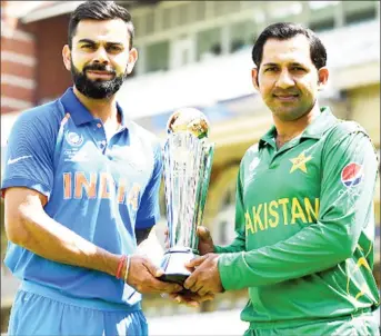  ??  ?? Captains, Virat Kohli, India and Sarfraz Ahmed, Pakistan, with the Champions Trophy.