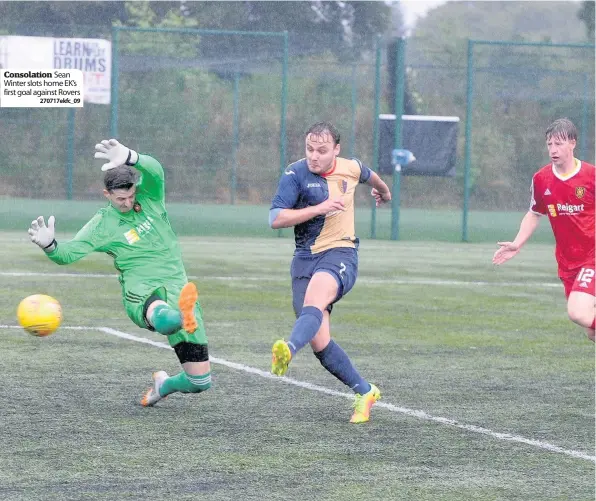  ??  ?? Consolatio­n Sean Winter slots home EK’s first goal against Rovers