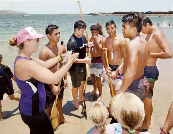  ?? The Maui News / MATTHEW THAYER photo ?? Na Kai Ewalu keiki head coach Stephanie Franklin talks to her Boys 16 paddlers after their race Saturday at Kahului Harbor