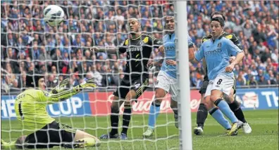  ?? Picture: REUTERS ?? IN THE BAG: Manchester City’s Samir Nasri scores against Chelsea during their FA Cup semifinal at Wembley Stadium in London yesterday evening. City fended off Chelsea to win 2-1, and will face Wigan Athletic in the FA Cup final.