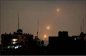  ?? AP/HATEM MOUSSA ?? Rockets fired by Palestinia­n militants blaze over the Gaza Strip toward Israeli lands Wednesday.