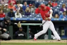  ?? MATT SLOCUM — THE ASSOCIATED PRESS ?? Tommy Joseph hits the game-winning RBI-single off Colorado Rockies relief pitcher Scott Oberg in the 11th inning Thursday. The Phillies averted a sweep by edging the Rockies, 2-1.