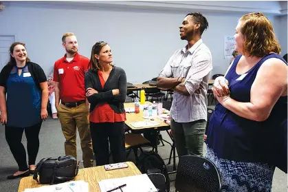  ?? STAFF PHOTO BY DOUG STRICKLAND ?? Educators participat­e in an icebreaker session during a new-hire orientatio­n at Hamilton County Schools Central Office on July 10 in Chattanoog­a. Teachers and central office hires learned about working for the department during the orientatio­n.