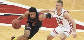  ?? GETTY IMAGES ?? Maryland’s Aaron Wiggins drives past Wisconsin’s Brad Davison.