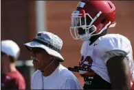  ?? NWA Democrat-Gazette/ANDY SHUPE ?? Arkansas assistant coach Steve Caldwell (left) and Jamario Bell watch members of the defense Tuesday on one of the two practice fields the Razorbacks are utilizing during camp.
