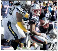  ?? AP/STEVEN SENNE ?? New England Patriots running back Sony Michel scores in front of Los Angeles Chargers defensive tackle Darius Philon (Arkansas Razorbacks) during the first half of Sunday’s AFC divisional playoff game in Foxborough, Mass. Michel ran for 129 yards and 3 touchdowns as the Patriots won 41-28.