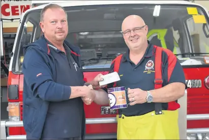  ??  ?? CHAMPIONS — Meoff Poker Run organiser Rodney Williams, left, with Kyabram CFA Captain Mick Crompton, right, celebratin­g an anonymous $2380 donation for Good Friday as well as the poker run’s $1000.