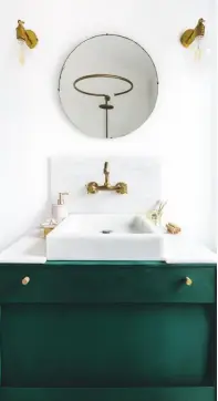  ??  ?? EN SUITE
‘I’m quite proud of the luxurious look we’ve achieved in here,’ says Onitha. Upcycled cabinet in Amsterdam Green, £19.95 for 1ltr, Annie Sloan. Brass wall sconces, £93.50 each, Khalima Lights