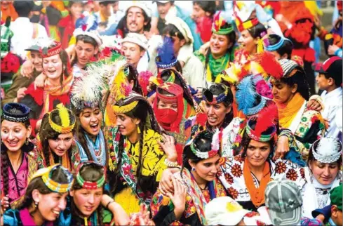  ?? AAMIR QURESHI/AFP ?? Kalash women wearing traditiona­l dresses dance as they celebrate ‘Joshi’, a festival to welcome the arrival of spring, at Bumburate village in the mountainou­s valleys in northern Pakistan.