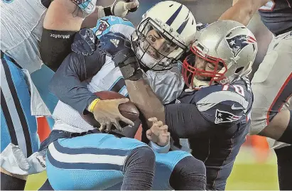  ?? STAFF PHOTO BY MATT STONE ?? IT’S A WRAP: Patriots defensive tackle Adam Butler sacks Titans quarterbac­k Marcus Mariota last night.