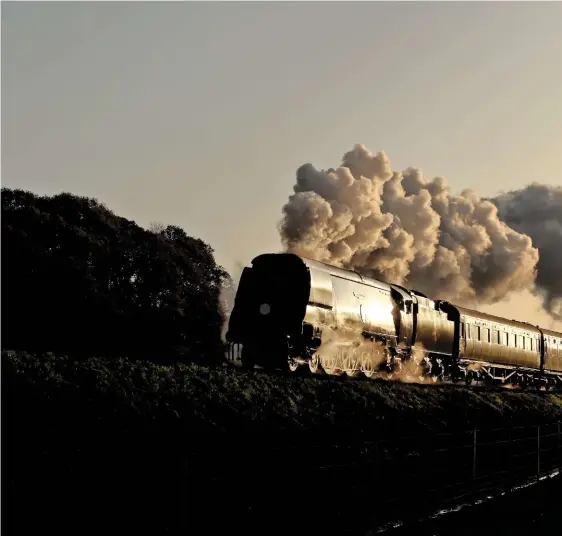  ?? RICHARD BELL ?? Michael Draper believes that preservati­on has largely abandoned re-creation. In a scene that bucks his perceived trend, No. 34072 257 Squadron chatters past New Barn on the Swanage Railway early on November 12 with a short train that evokes memories of the ‘Withered Arm’.