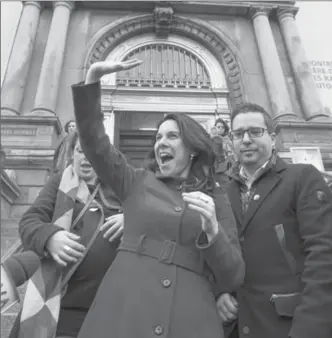  ?? PAUL CHIASSON, THE CANADIAN PRESS ?? Montreal’s new mayor, Valerie Plante, waves from the front steps of City Hall Monday. Plante scored a stunning upset in Montreal’s mayoral election on Sunday, defeating incumbent Denis Coderre to become the first woman to win the post.