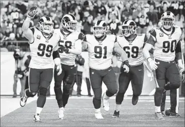  ?? Wally Skalij Los Angeles Times ?? AARON DONALD (99) celebrates with the defense after helping sack Steelers quarterbac­k Mason Rudolph for a fourth-quarter safety that pulled the Rams to within 14-12. But they could get no closer.