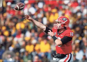  ?? Todd Kirkland / Getty Images ?? Georgia’s JT Daniels passes in Saturday’s game against Missouri at Sanford Stadium in Athens, Ga.