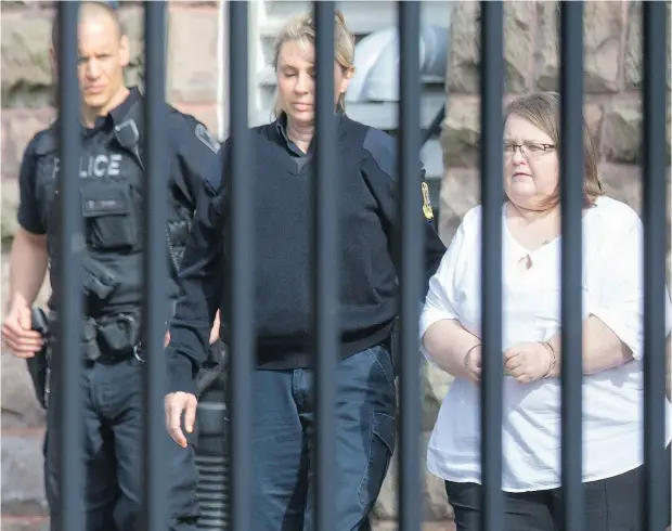  ?? PETER POWER / THE CANADIAN PRESS ?? Elizabeth Wettlaufer is escorted from the courthouse in Woodstock, Ont., on Thursday after admitting she used insulin to kill eight seniors.