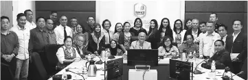  ??  ?? Minos (seated centre) and Florince (seated third right) in a group photo with representa­tives of several Dayak-based NGOs, public tertiary institutio­ns and government agencies. – Photo by Churchill Edward