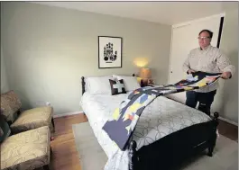  ?? PICTURE: BEN MARGOT/AP ?? A man prepares a room to rent on Airbnb. Patrick Leclezio’s recent trip to Rio made him rethink his support for the concept.