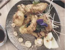  ??  ?? Squid tempura, above, and tempura scampi and Umai rolls, below, at Umai Sushi and Ramen Kitchen