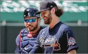  ?? CURTIS COMPTON/CURTIS.COMPTON@AJC.COM ?? Braves right-hander Ian Anderson and catcher Travis d’arnaud are all smiles after Anderson pitched two scoreless innings in a 6-0 win against the Twins on Tuesday at Cooltoday Park in North Port, Florida.