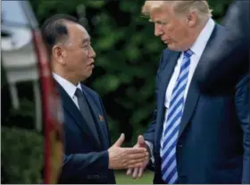  ?? ANDREW HARNIK — ASSOCIATED PRESS FILE PHOTO ?? In this June 1, 2018, file photo, U.S. President Donald Trump, right, shakes hands with Kim Yong Chol, former North Korean military intelligen­ce chief and one of leader Kim Jong Un’s closest aides, as after their meeting in the Oval Office of the White House in Washington. Ahead of a planned summit Tuesday, June 12, in Singapore between President Donald Trump and North Korean autocrat Kim Jong Un, there has been talk of complete denucleari­zation, North Korea has shut down (for now) its nuclear test site, and senior U.S. and North Korean officials have shuttled between Pyongyang and Washington for meetings with Kim and Trump.