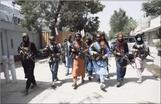  ?? Rahmat Gul / Associated Press ?? Taliban fighters patrol in the Wazir Akbar Khan neighborho­od in the city of Kabul, Afghanista­n, on Wednesday.