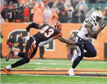  ?? USA Today Sports ?? Playing catch- up San Diego Chargers running back Ronnie Brown ( right) evades Cincinnati Bengals safety George Iloka to complete a 58- yard touchdown run in the fourth quarter on Sunday.