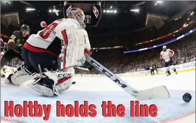  ?? HARRY HOW / POOL VIA AP ?? Washington Capitals goaltender Braden Holtby, right, stops a shot by Vegas Golden Knights left wing Tomas Nosek, of the Czech Republic, during the second period in Game 1 of the NHL hockey Stanley Cup Finals Monday in Las Vegas.