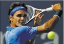  ??  ?? Roger Federer of Switzerlan­d returns a shot to Carlos Berlocq of Argentina at the U.S. Open in New York on Thursday.
