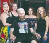  ??  ?? Barber Jason Gauthier (seated) poses for a picture with his staff during the grand opening of his new business Straighted­ge Barber, located on 22 Fairford Street West, on July 12. From left are manager Amanda (M) McClean, head barber Kyla Jackson, and journeymen barbers Kendra Marchand and Ashley Amberson. Photo by Jason G. Antonio