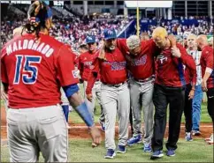  ?? David Santiago / TNS ?? Puerto Rico pitcher and Mets closer Edwin Diaz is led from the field after his injury Wednesday at the World Baseball Classic.