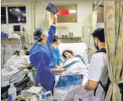  ??  ?? Doctors attend to a Covid-19 patient at the Holy Family Hospital in New Delhi.