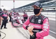  ?? Darron Cummings / Associated Press ?? Helio Castroneve­s waits in the pits before a practice session for a IndyCar race at Indianapol­is Motor Speedway on Friday.