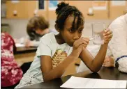  ??  ?? Third-graders learn to use the tools of a scientist in the lab.