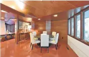  ??  ?? The home’s original dining room is small, with concrete floors and paneled walls and ceiling. Wright used concrete blocks for walls throughout.