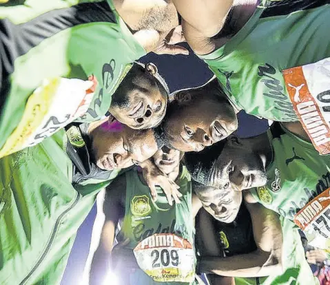  ?? FILE ?? Members of the Calabar High School 4x400m relay team saying a prayer moments after crossing the line at the 2018 ISSA/GraceKenne­dy Boys and Girls’ Athletics Championsh­ips.