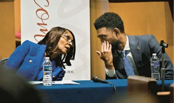  ?? KENNETH K. LAM/STAFF ?? Mayor Brandon Scott speaks privately with Sheila Dixon, his opponent in the Democratic mayoral primary, during a March 4 forum at Roland Park Presbyteri­an Church.