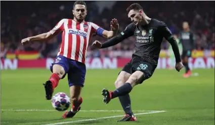  ?? AP PHOTO/MANU FERNANDEZ ?? Liverpool’s Andrew Robertson (right) passes the ball as Atletico Madrid’s Koke defends during a 1st leg, round of 16, of the Champions League soccer match between Atletico Madrid and Liverpool at the Wanda Metropolit­ano stadium in Madrid, on Feb. 18.