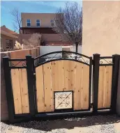 ??  ?? Custom gates with metal work and wood help add security to a yard.