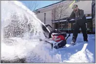  ??  ?? Timmy Poe, a chemical division supervisor for Horticare Landscape Companies, uses a snow blower last month to clear the sidewalks around the Promenade at Chenal in Little Rock. (Arkansas Democrat-Gazette/Staci Vandagriff)