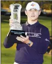  ??  ?? Si Woo Kim holds the winner’s trophy at the end of The American Express golf tournament on the Pete Dye Stadium Course at PGA West, on Jan 24, in La Quinta, Calif. (AP)