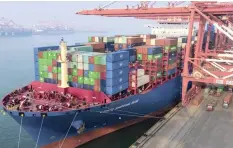  ?? | Chinatopix via AP ?? CONTAINERS are loaded on to a cargo ship at the port in Qingdao in China’s Shandong province. Markets are optimistic that the formal talks between China and the US will result in a trade deal.