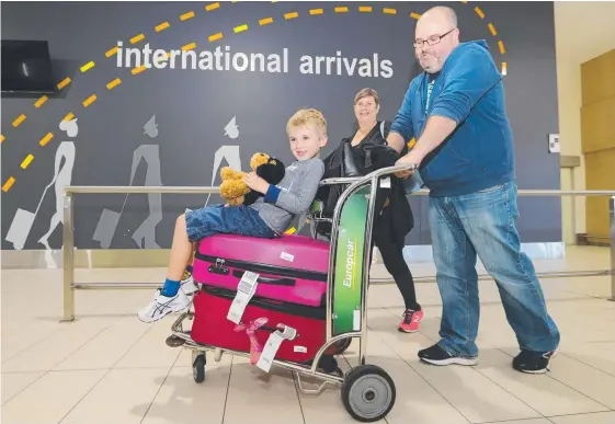  ?? Picture: GLENN HAMPSON ?? Carole and Scott Oliver, and their son Jack, 7, arrived on the Gold Coast from Auckland yesterday. More than 50,000 of their countrymen passed through Gold Coast Airport last month, up nearly 7 per cent on the same month last year.