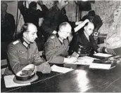  ?? AP FILE ?? Gen. Alfred Jodl (center) signs the unconditio­nal surrender of all armed German forces in 1945.