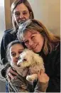  ?? Jessica Hartman via AP ?? Zoey is cuddled by Helen Welch, left, and Monica Newhard. Christina Hartman saved the dog.