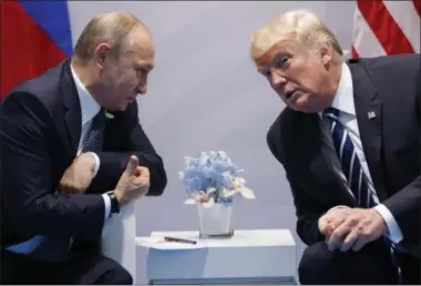  ?? PHOTOS BY THE ASSOCIATED PRESS ?? In this July 7, 2017, file photo, President Donald Trump meets with Russian President Vladimir Putin at the G20 Summit in Hamburg, Germany. Trump had a second, previously undisclose­d conversati­on with Putin at the summit it Germany. White House...