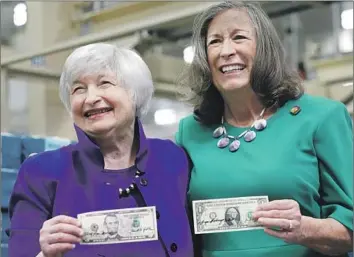  ?? LM Otero Associated Press ?? TREASURY SECRETARY Janet Yellen, left, and U.S. Treasurer Lynn Malerba show off money they autographe­d Thursday during a tour of the Bureau of Engraving and Printing’s currency facility in Fort Worth.