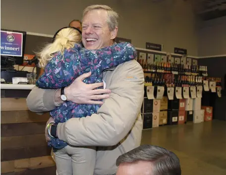  ?? BOSTON HERALD FILE, ABOVE; ANGELA ROWLINGS / HERALD STAFF FILE ?? POPULAR: Gov. Charlie Baker is hugged by Angelina Tamberino, 8, of North Andover during a tour last week of North Andover. Baker was named the nation’s most popular governor for the second year in a row in a quarterly ranking. ‘It’s no small feat to maintain the high level of popularity that Gov. Baker has for several years now,’ Republican consultant Ryan Williams says.