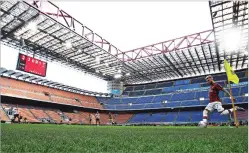  ?? COURTESY SPADA ?? AC Milan’s Samu Castillejo kicks from the corner in an empty stadium during the Serie A match Sunday between AC Milan and Genoa at the San Siro stadium, in Milan, Italy. Serie A played on despite calls from Italy’s sports minister and players’ associatio­n president to suspend the games in Italy’s top soccer division.